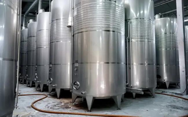 1000 litre stainless steel chemical storage tanks in industrial facility